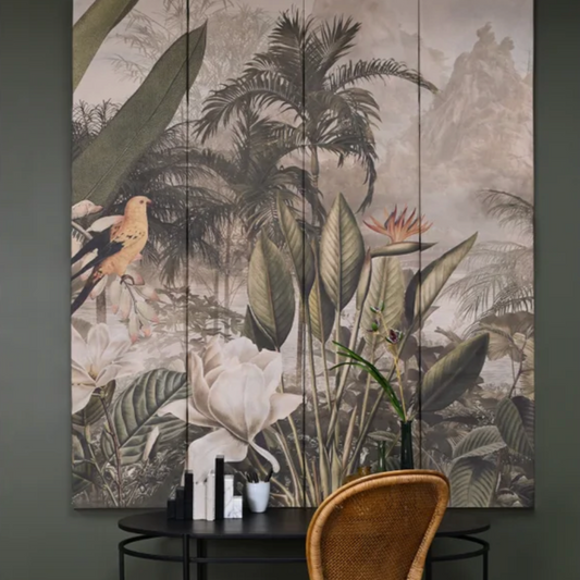 Tropical-themed wall art above a table with a wicker chair in a room setting.