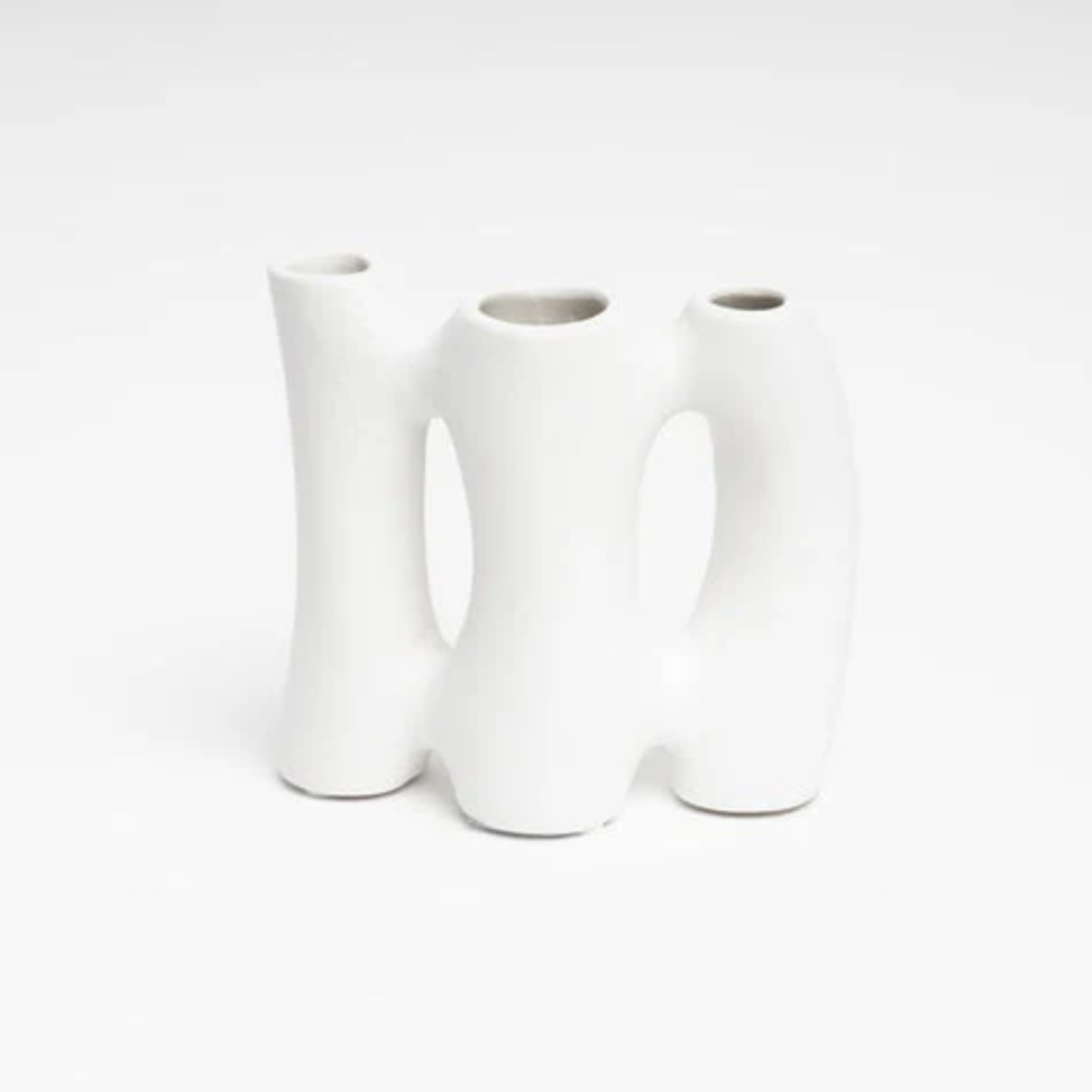 Three white ceramic vases on a white background