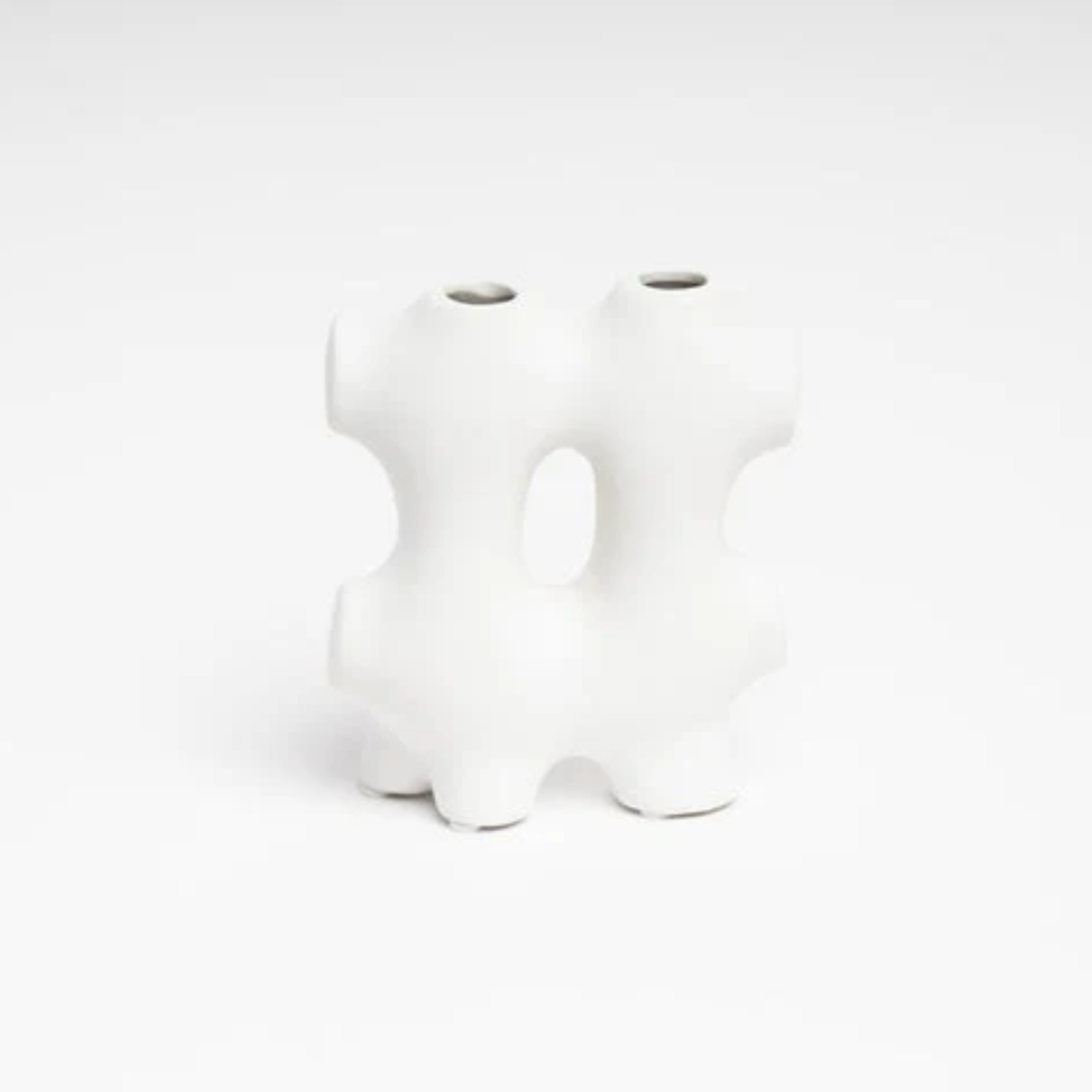 White ceramic puzzle piece on a white background