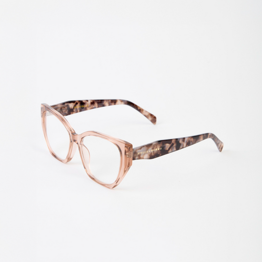 Eyeglasses with a transparent beige frame and tortoiseshell accents on a white background
