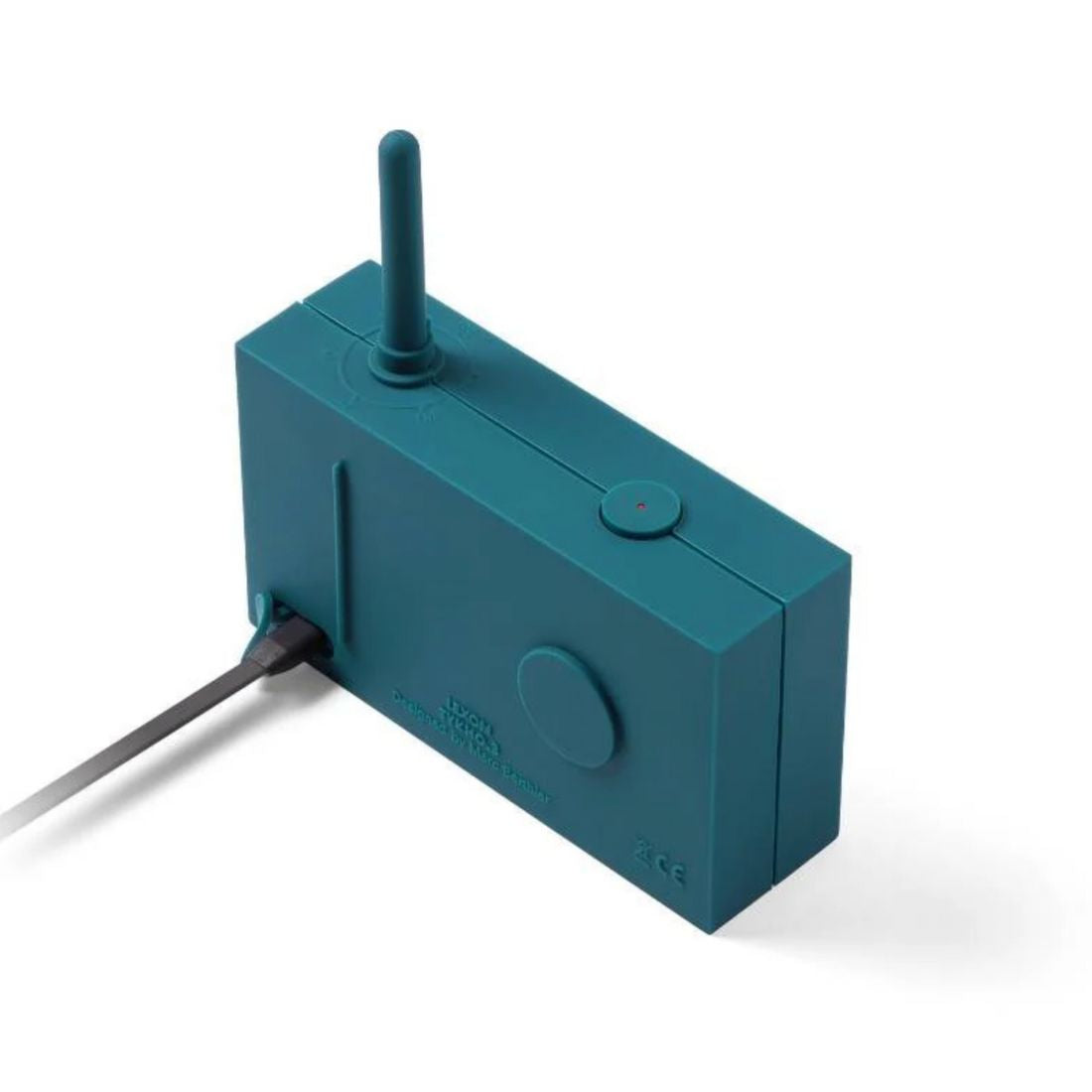 Teal blue portable radio with antenna and charge cable plugged in on a white background