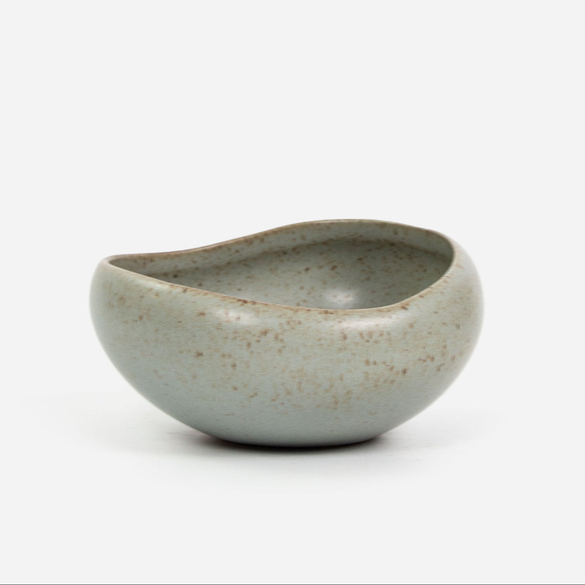Olive ceramic bowl with speckled texture on a white background