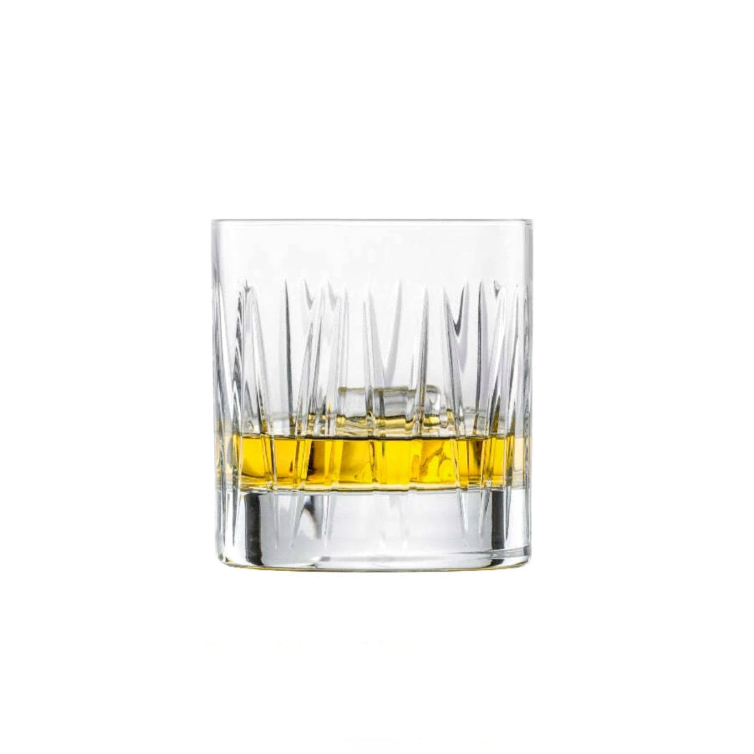 Clear glass with a small amount of yellow whisky liquid on a white background