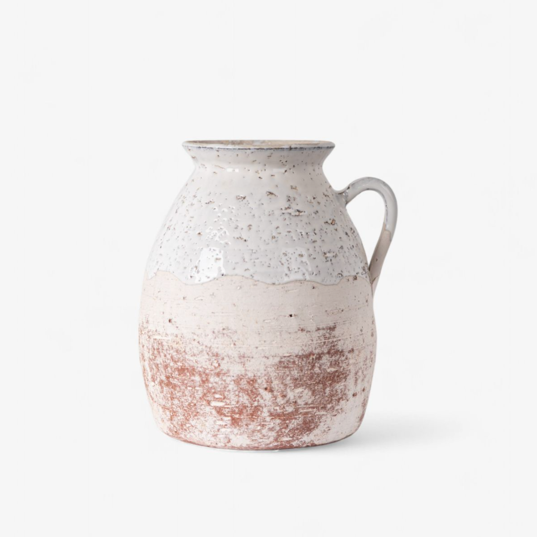 Ceramic pitcher with speckled design on a white background