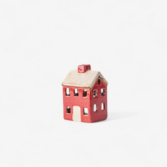 Small red house-shaped object on a white background