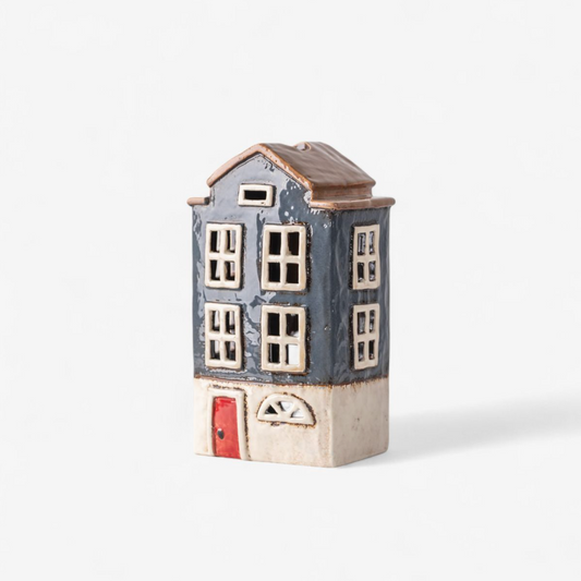 Ceramic house with red door on a white background