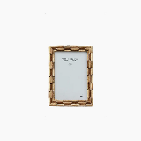 Champagne metal picture frame on a white background
