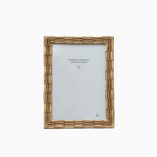 Champagne metal picture frame on a white background
