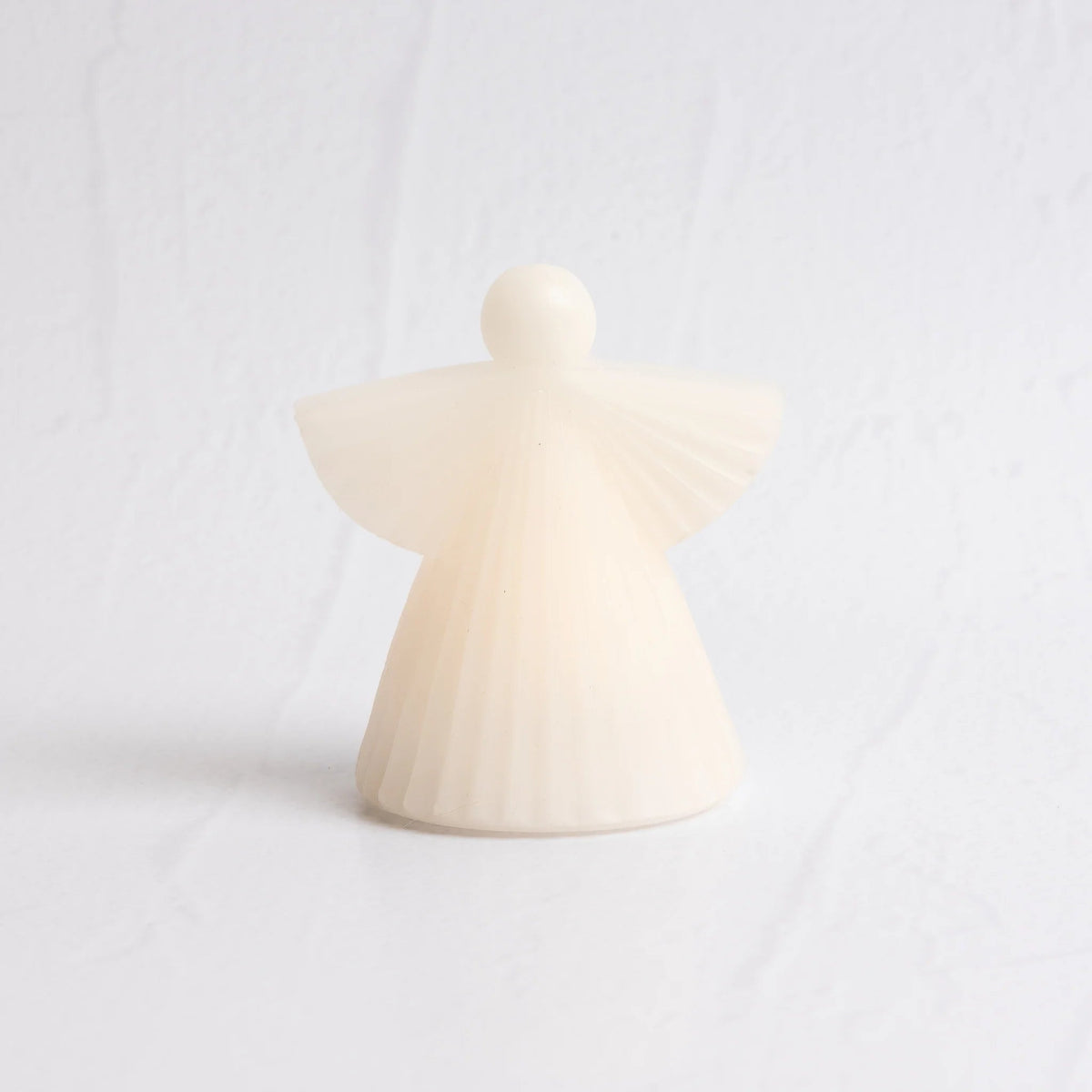 White wax LED angel candle on a white background
